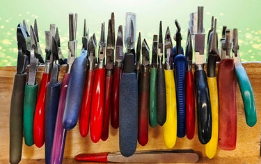 A row of different types of jewelry pliers.