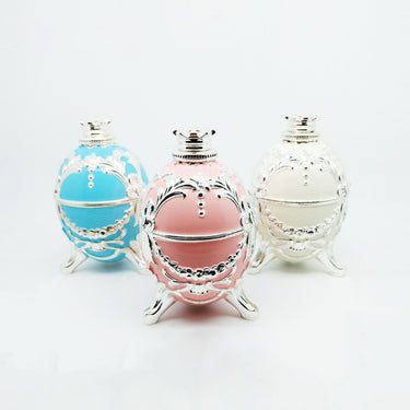 Three Alfa Mirage Happy Egg diamond viewers in blue, pink, and ivory with silver retro carved textures.