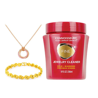 Connoisseurs Fine Jewelry Cleaner for gold and diamonds shown with a gold necklace and bracelet.