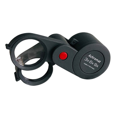 Eschenbach Achromat folding magnifier showing the 3x, 6x, and 9x magnification levels on a black plastic case.