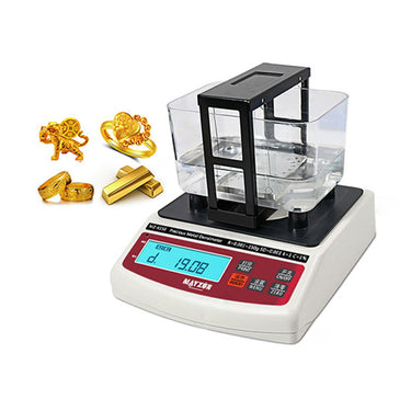 Gold and platinum tester MZ-K150 shown next to illustrative gold rings, bars, and a tiger figurine.