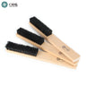 A trio of ORO straight black bristle cleaning brushes with natural wood handles stacked together.