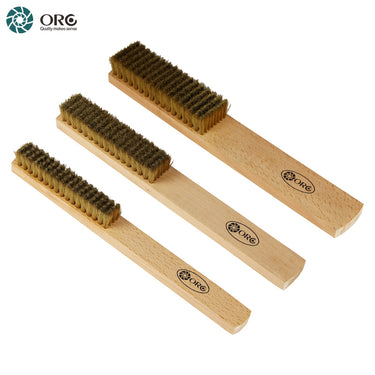 Three different sizes of ORO brass wire scratch brushes with wooden handles arranged diagonally on white background.