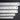 Five stainless steel rulers of varying lengths stacked horizontally from largest to smallest.