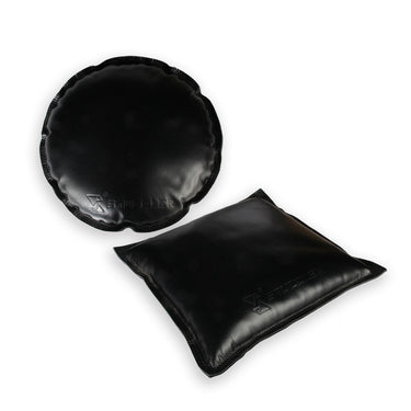 One round and one square black leather Stuccler sandbag for jewelry metal stamping and forming.