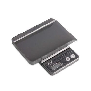 Tanita 1475T digital scale shown with its removable protective tray cover positioned above.