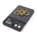 Tanita 1475T mini scale weighing multiple gold rings on its dark grey platform.