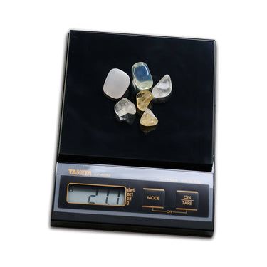 Tanita KP-400M scale measuring small polished gemstones with a 21.1g digital readout.