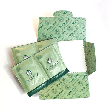 Town Talk Pearl Care Tissues, individually packaged in green foil packets and an open cardboard sleeve, designed for cleaning delicate pearls.