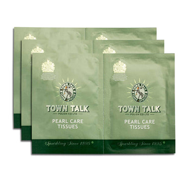 A stack of individual Town Talk Pearl Care Tissues packets in green foil, featuring the "Sparkling Since 1895" tagline.