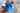 Close-up of hands polishing a silver diamond engagement ring with a blue microfiber jewelry cleaning cloth.