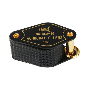 Closed Alfa Mirage 30x loupe showing the compact design, gold-tone hardware, and protective metal casing.