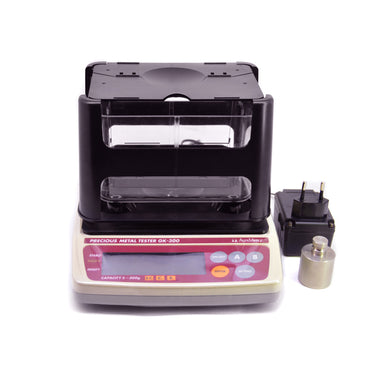 Front view of Alfa Mirage GK-300 gold tester with a calibration weight and adapter.