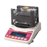 Alfa Mirage GKS-300 precious metal tester weighing a gold chain and jewelry.