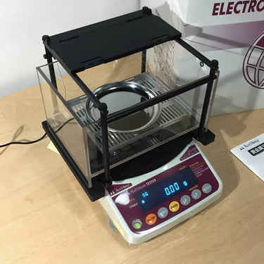 Alfa Mirage GKS-3000 density tester with transparent water tank and stainless tray.