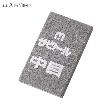 Detail view of the Medium grit Alfa Mirage Sabito-ru Sanding Rubber with its white Japanese label.