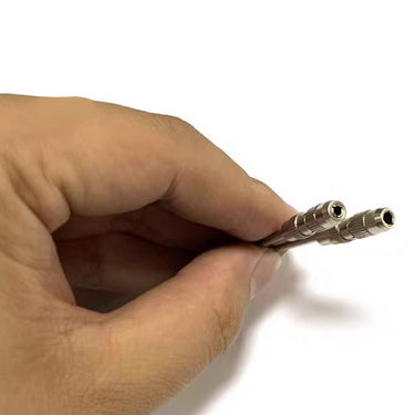 Close-up of a hand holding two miniature pin mandrels showcasing the openings of the clamping collets