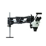 Complete spring model stereo microscope system mounted on fully extended articulated spring arm stand.