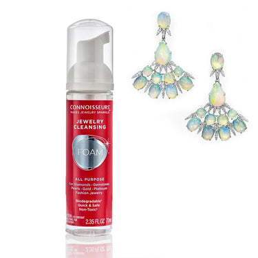 Connoisseurs jewelry cleansing foam bottle with elegant opal and diamond earrings.
