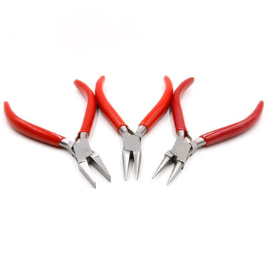 A set of three red-handled DICK jewelry pliers spread out on a white background.