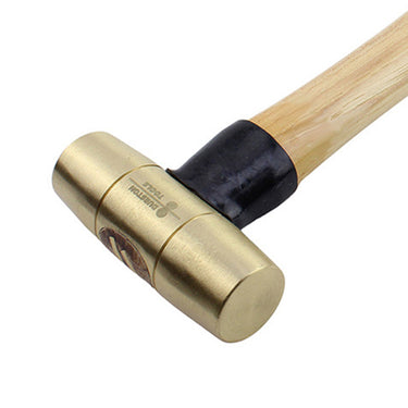 Close-up of a Durston 2lb solid brass mallet head highlighting the cylindrical striking face and brand detail.