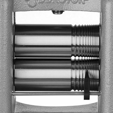Close up view of the flat and square wire grooved combination steel rollers on a DRM C150RE rolling mill
