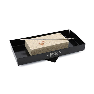 Black rotating stand supporting a fire brick with copper jump rings and a soldering probe.