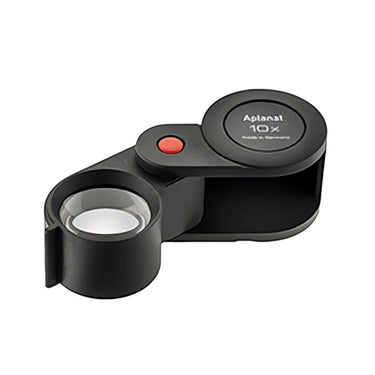 Angled view of the Eschenbach 10X Aplanat plastic folding loupe showing the thick magnifying lens.