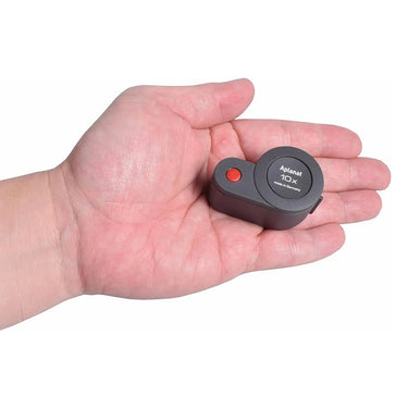 Closed Eschenbach 10X plastic folding magnifier resting in a hand to demonstrate its compact size.