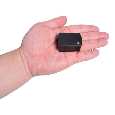 A compact Eschenbach 10x magnifier held in a palm to demonstrate its small, portable size.
