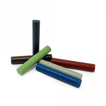 A group of 3x23mm EVE Eveflex silicone polishing pins scattered on a white background.