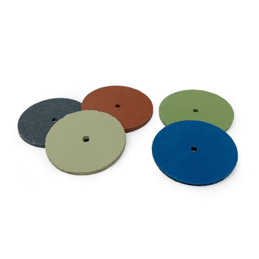 A small group of colored EVEFLEX silicone jewelry polishing discs scattered on a white background.