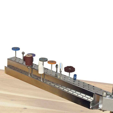 Perspective view of Foredom bur holder arm storing grinding burs above a wooden workbench.