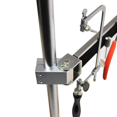 Close-up of Foredom magnetic arm mounting bracket holding jeweler saw frame and pliers. 