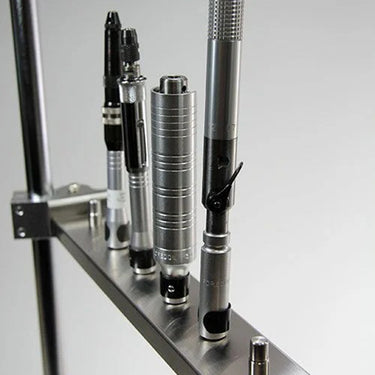 Angled view of Foredom multi handpiece arm storing rotary handpieces in a neat row.