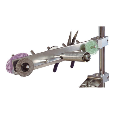 Left angle view of Foredom peg arm organizing rotary handpiece, polishing discs, and pliers.