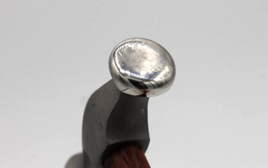 Macro detail of Fretz HMR-6 mirror polished slightly domed 19mm stainless steel striking face