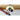 Fretz HMR-8 rounded narrow raising hammer shaping a fluted gold brass cuff over a metal stake.
