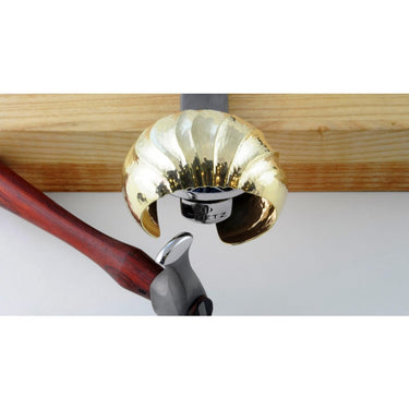 Fretz HMR-8 rounded narrow raising hammer shaping a fluted gold brass cuff over a metal stake.
