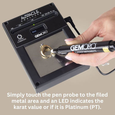 Touching pen probe to metal; LED indicates karat value or Platinum (PT).