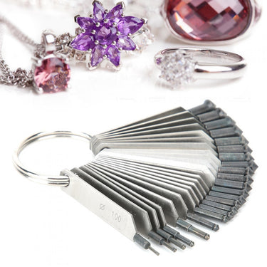 Gemstone measuring gauge fan set below elegant purple flower jewelry pieces.