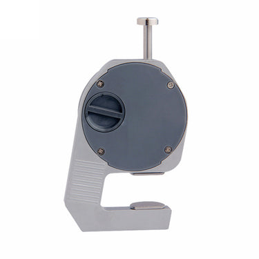 The reverse side of a digital thickness micrometer showing the circular plastic battery compartment cover.