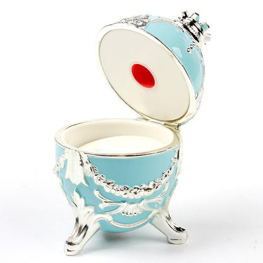 Open blue Happy Egg jewelry box showing the interior ring slot and built-in magnifying lens.