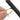 Close up of a jeweler holding a gold ring and polishing the surface with an abrasive sanding stick
