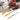 Set of three jewelry blowpipe torches with background demonstration of ring soldering with a pick.