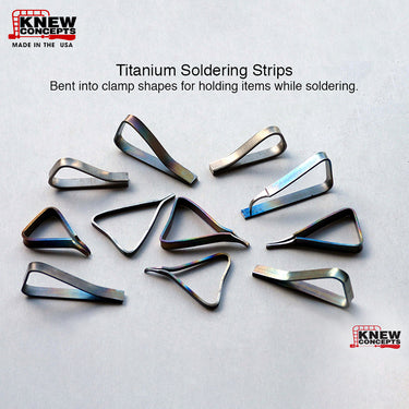Assortment of heat-treated titanium strips bent into unique triangle and loop clamp shapes for jewelry welding