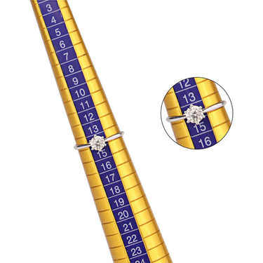 A diamond engagement ring placed on the gold aluminum light ring stick mandrel to verify its size.