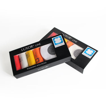 Two closed LUXOR Merard jewelry polishing kit boxes showing the compound and buff packaging.