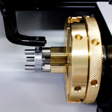 Close up view of the internal brass rotary chuck assembly holding pin fixtures inside the machine