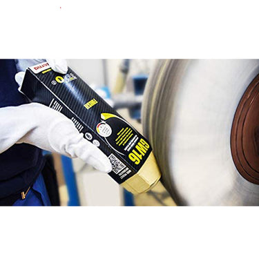 Applying Menzerna GW16 solid polishing compound to a rotating buffing wheel.